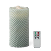 Flickering candle with wavy pattern and remote control on a white background