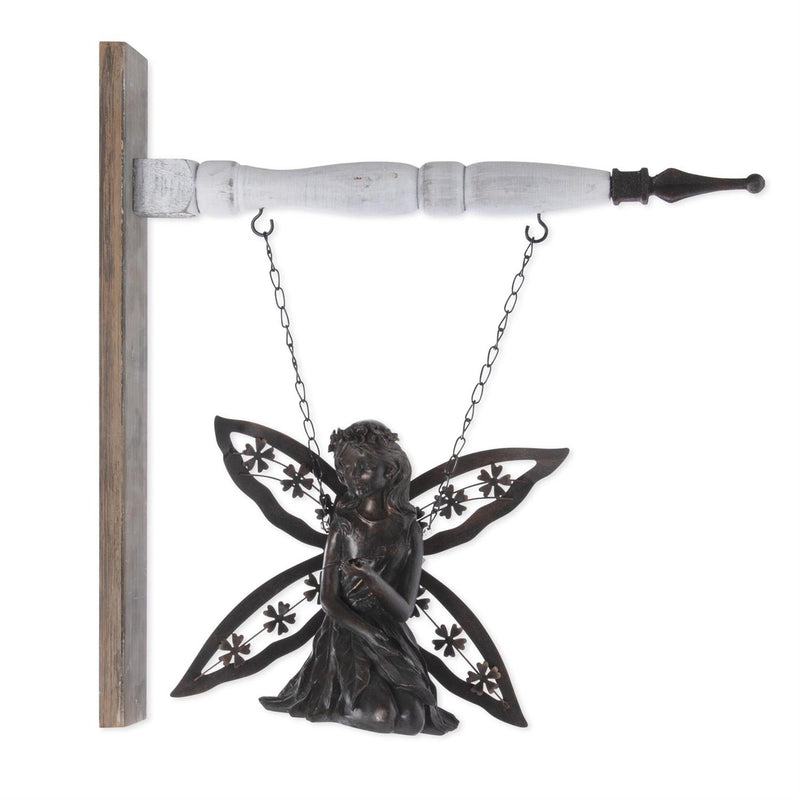 Decorative fairy figure hanging from a hook on a white background