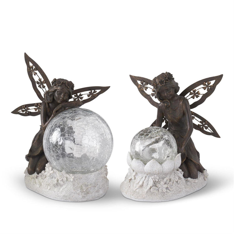 Two fairy figurines with crystal balls on a white background