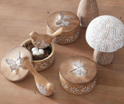 Wooden decorative items with animal and nature-themed designs on a wooden surface