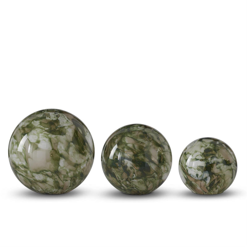 Three green marbled spheres of different sizes on a white background