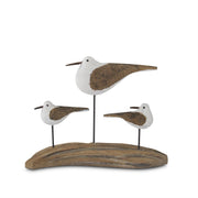 Decorative sculpture of three birds on a wooden base against a white background