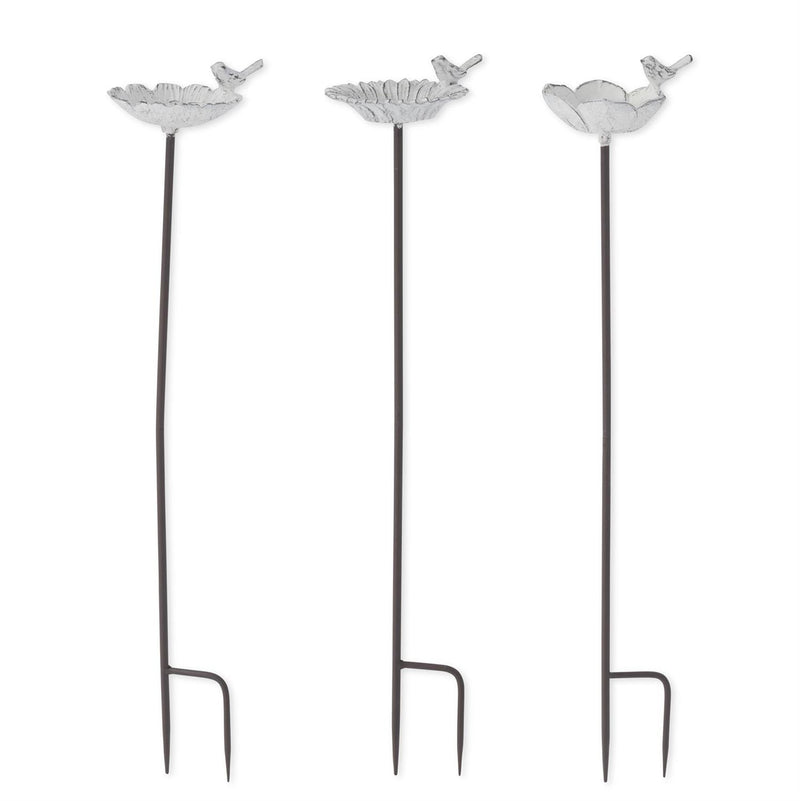 Three decorative metal plant stands with bird designs on a white background