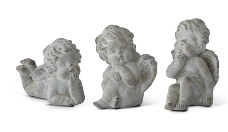 Three stone angel figurines on a white background