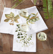 White napkins with floral designs on a wooden surface