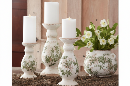 Decorative candles and floral arrangement on a wooden surface