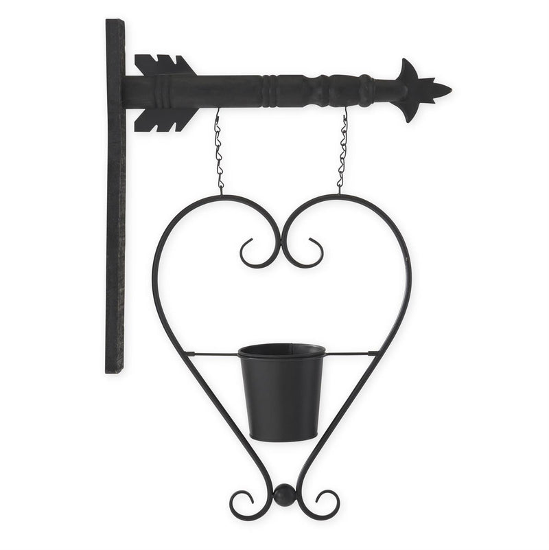 Black metal wall-mounted plant holder shaped like a heart on a white background