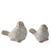 Two ceramic bird figurines on a white background