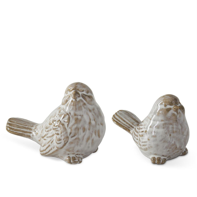 Two ceramic bird figurines on a white background