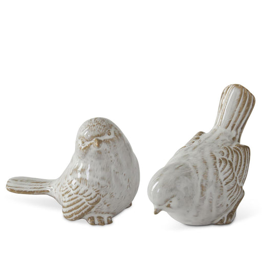 Two ceramic bird figurines on a white background