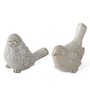 Two ceramic bird figurines on a white background