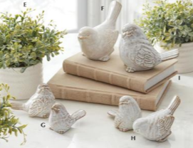 Decorative stone birds on books with a natural background