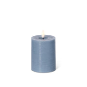 Blue battery operated candle on a white background.