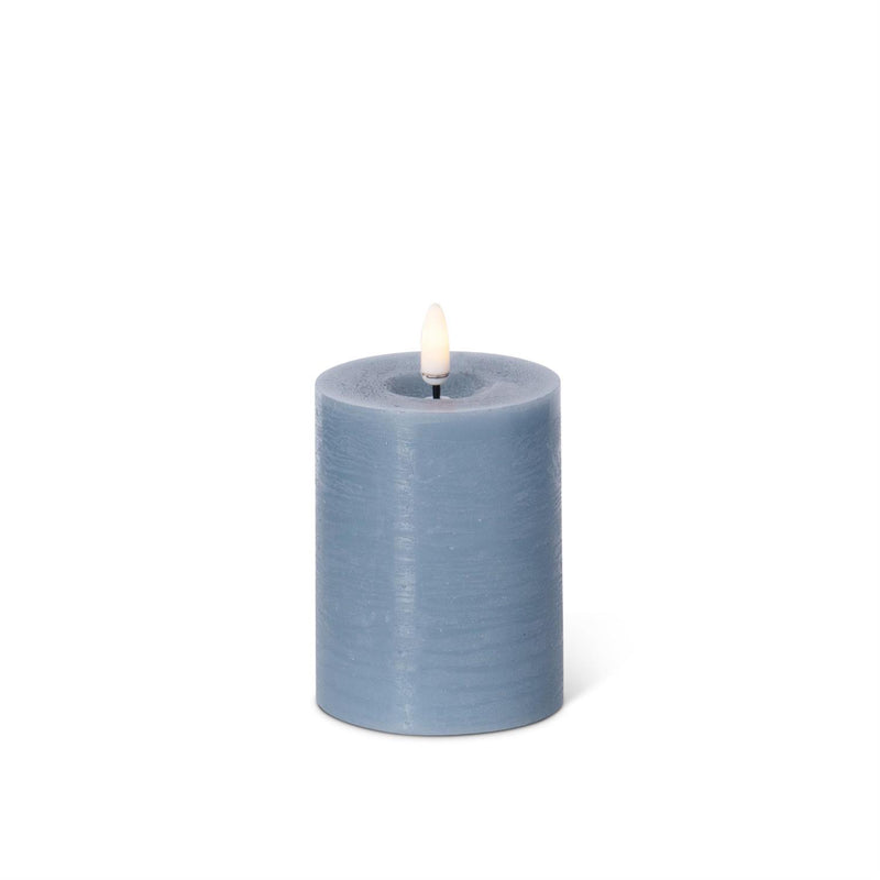 Blue battery operated candle on a white background.