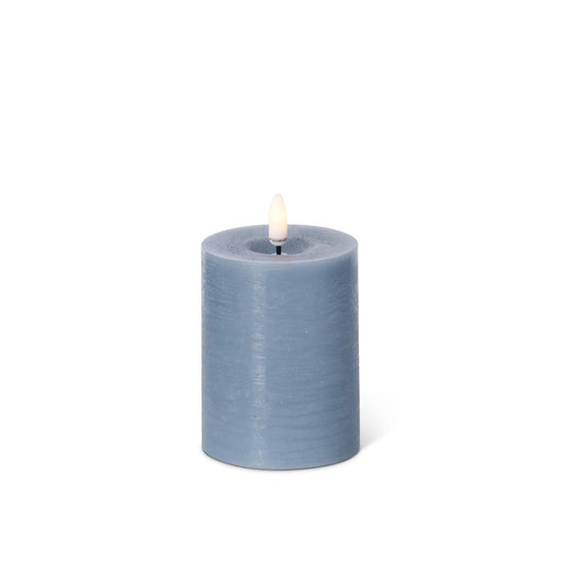 Blue battery operated candle on a white background.