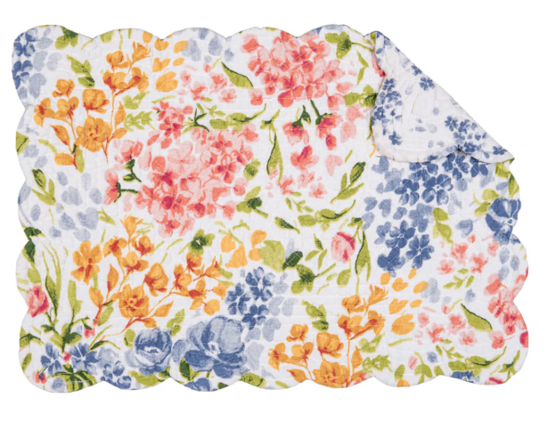 Floral-patterned placemats with scalloped edges on a white background