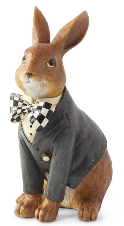 Wooden rabbit figurine wearing a suit and bow tie on a white background