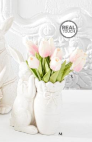 White ceramic vase with pink tulips on a white background
