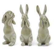 Three stone rabbit statues with different poses on a white background