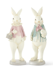 Two decorative rabbit figurines wearing outfits on a white background