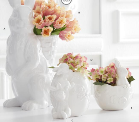 White ceramic vases shaped like animals with flowers inside on a white background