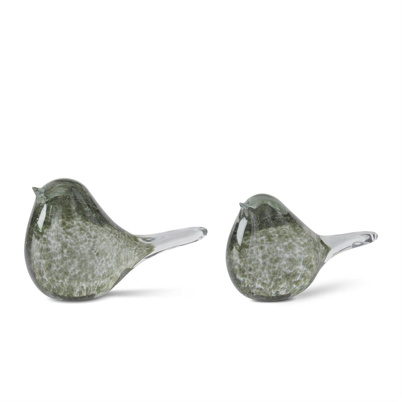 Two green glass birds on a white background