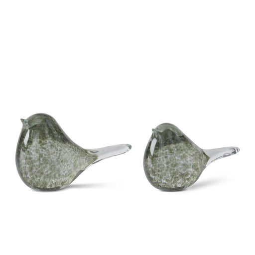 Two green glass birds on a white background