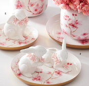 Decorative ceramic pieces with floral designs on a matching table setting.