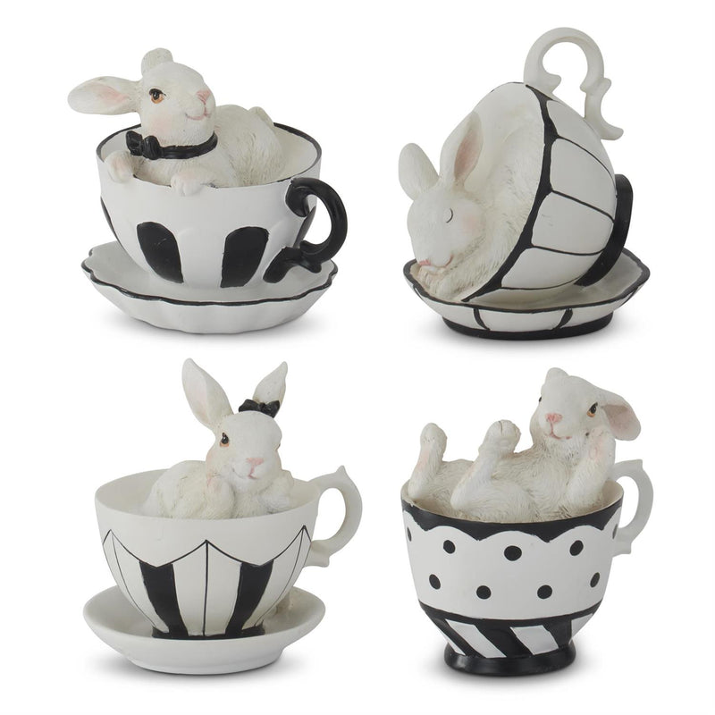 Set of four decorative teacups with rabbits inside on a white background