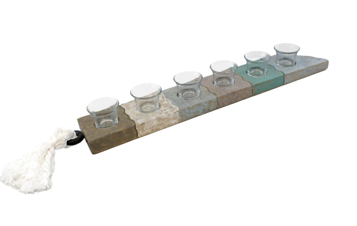 Decorative menorah with glass candle holders on a white background