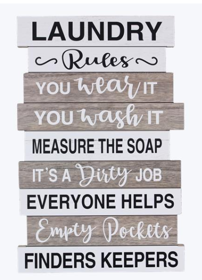 Stack of wooden signs with humorous laundry-themed sayings on a white background