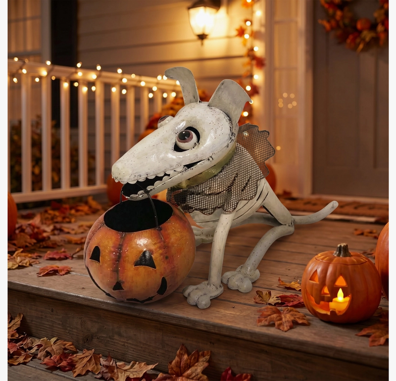 Halloween-themed decorative dog with a pumpkin on a porch decorated for fall.