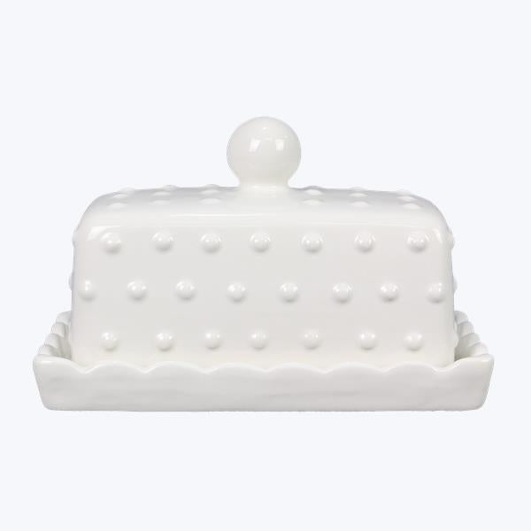 White ceramic butter dish with a textured surface and lid on a white background