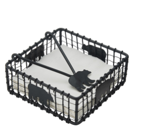 Black wire basket with decorative cut-out shapes on a white background
