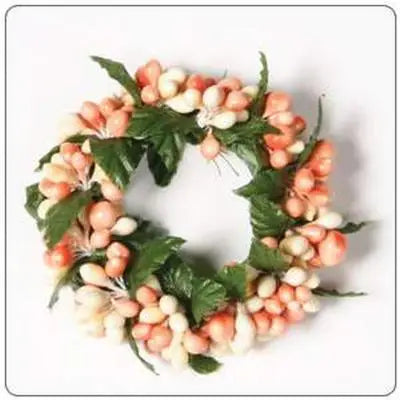 Decorative wreath with pink berries and green leaves on a white background