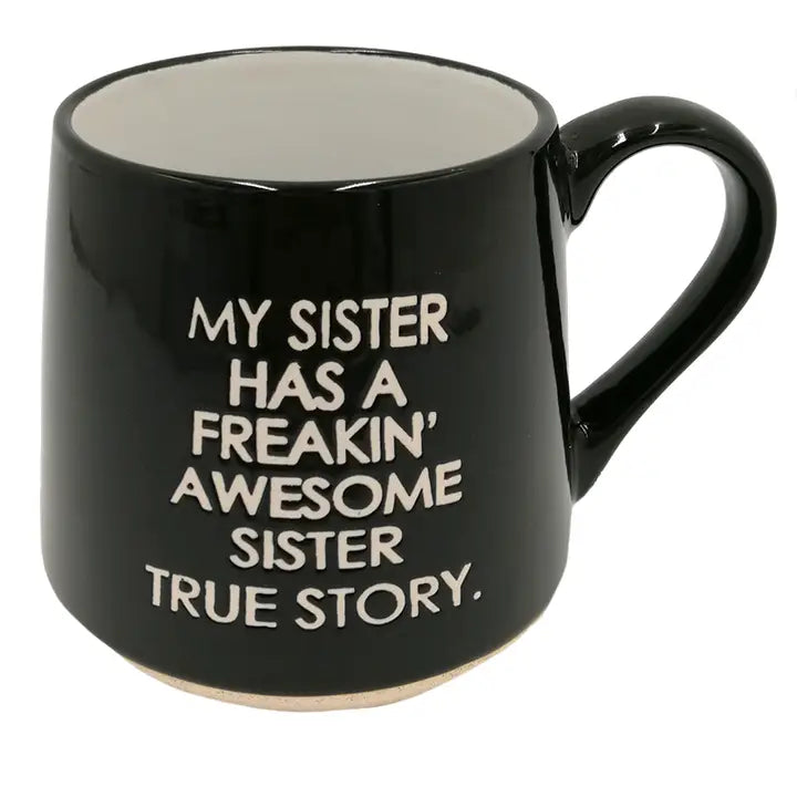 Black mug with white text on a white background