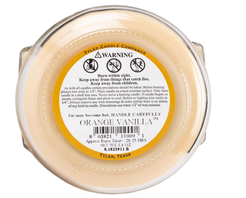 Tyler Candle Company candle with warning label and 'Orange Vanilla' description on a white background