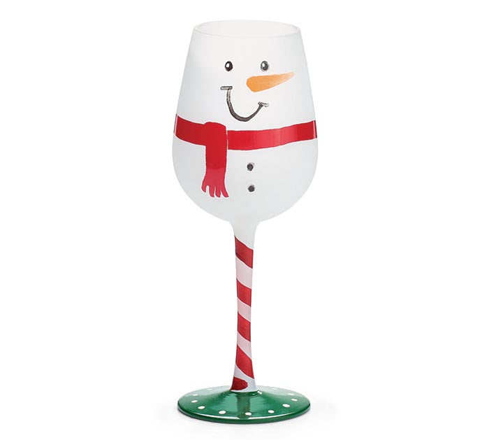 Wine glass designed like a snowman with a red scarf, candy cane stem, and green base on a white background.