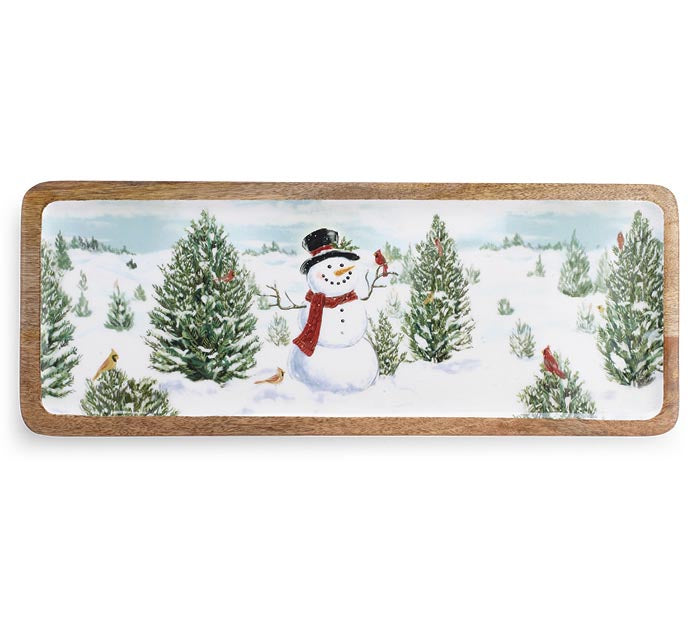 A rectangular wooden decorative board featuring a painted winter landscape with a snowman, evergreen trees, and small birds on a white background.