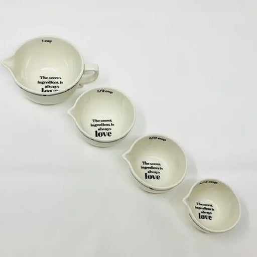 Set of white measuring cups with black text on a white background