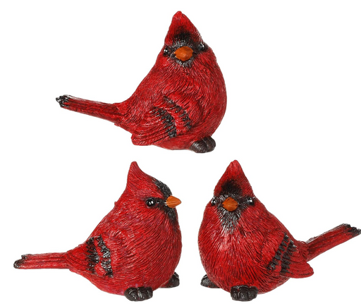 Three red cardinal bird figurines on a white background