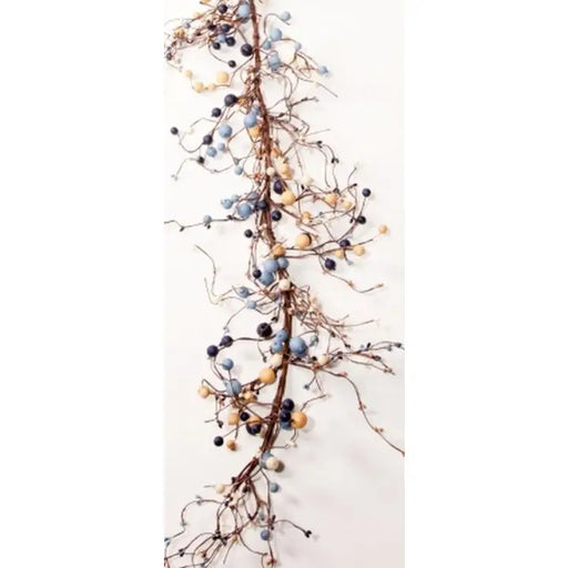 A decorative garland featuring natural brown branches adorned with small blue, navy, beige, and white berries, shown against a plain white background.