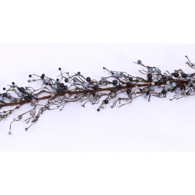 A decorative garland featuring a brown twig branch adorned with small black berries, pale gray beads, and metallic silver wire details, laid horizontally on a plain white background.