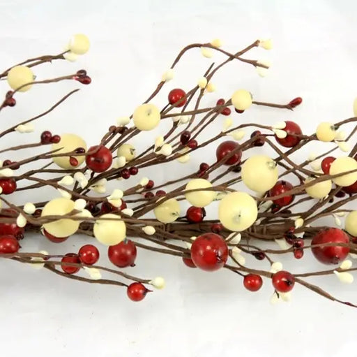 Decorative branch with red and yellow berries on a white background