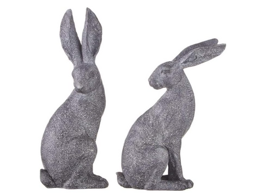 Two gray glittery rabbit statues on a white background