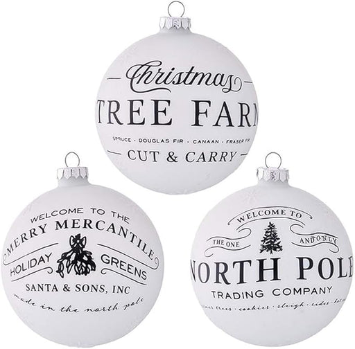 Three white Christmas ornaments with black text and graphics on a white background