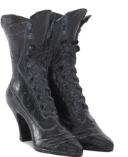 Pair of black lace-up boots on a white background