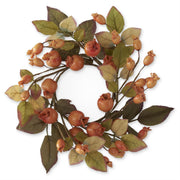 Decorative wreath with autumnal fruits and leaves on a white background