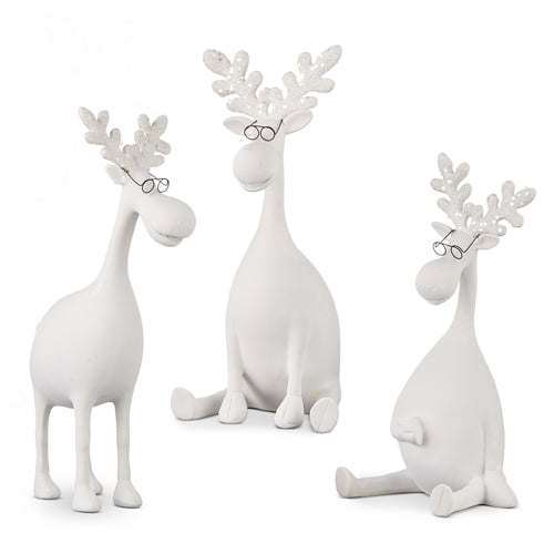 Set of three white moose figurines, each with a different seating position, wearing glasses and designed as decorative items.