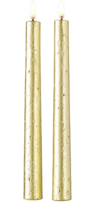 Two gold candles on a white background